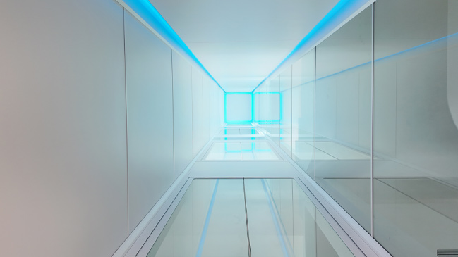 Blue illuminated glass lift shaft