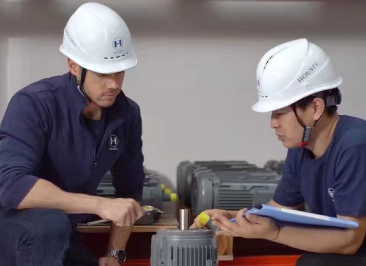 HOUSTY engineers examining lift components