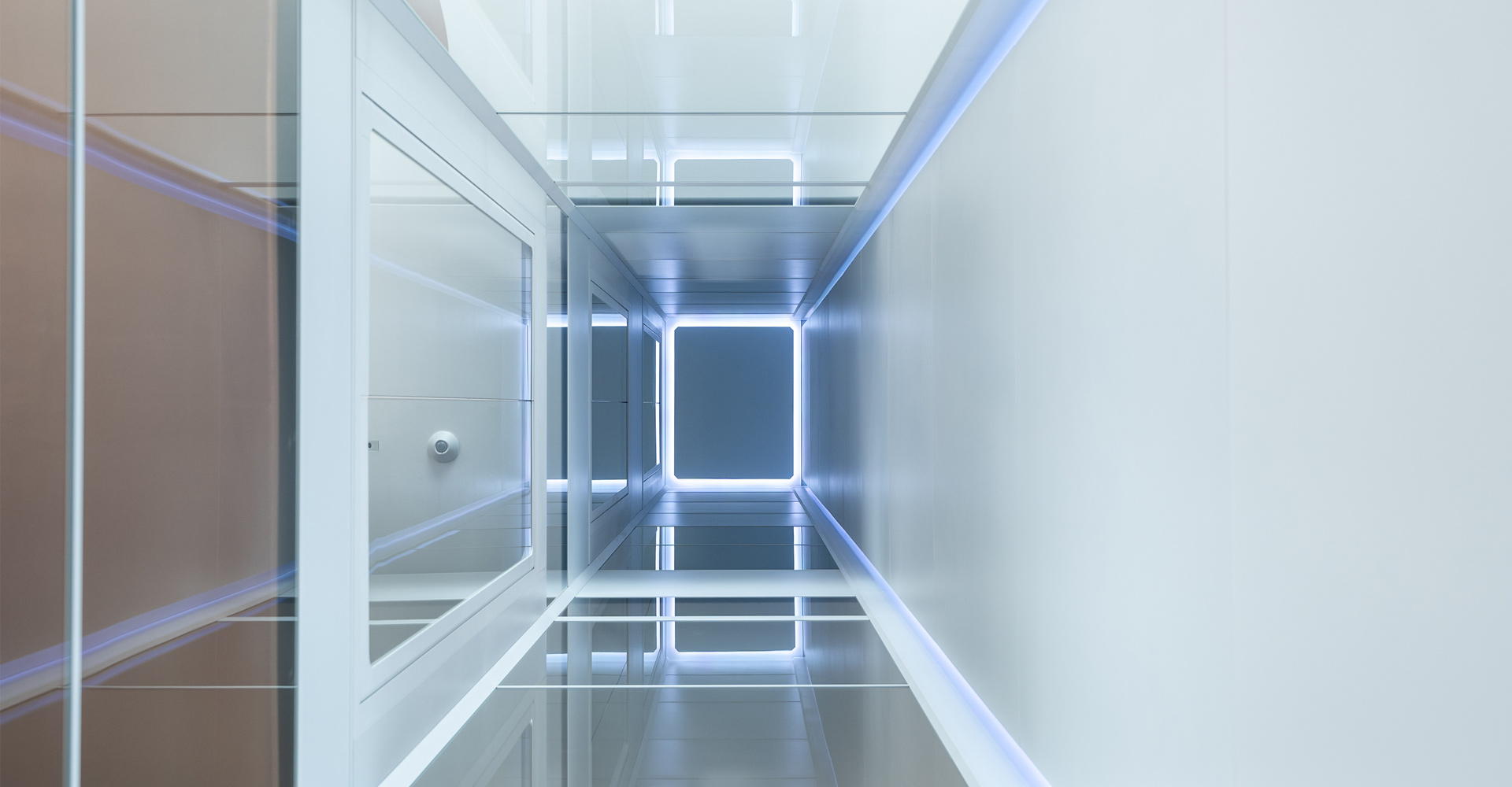 Looking upward through an illuminated HOUSTY lift